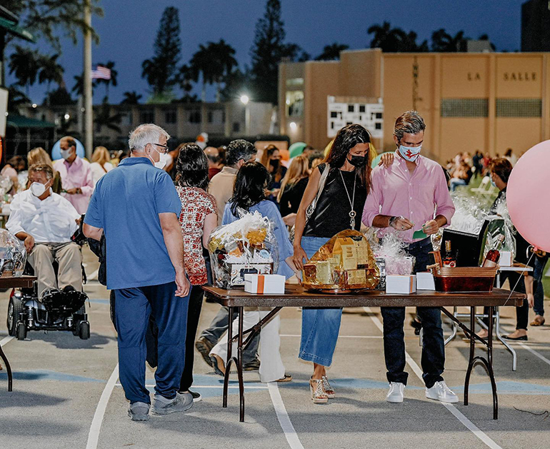 Immaculata-La Salle High School parents and benefactors take part in the Tricky Tray fundraising event March 18, 2021. Funds will go toward a new athletic field and fine arts building at the Miami high school.