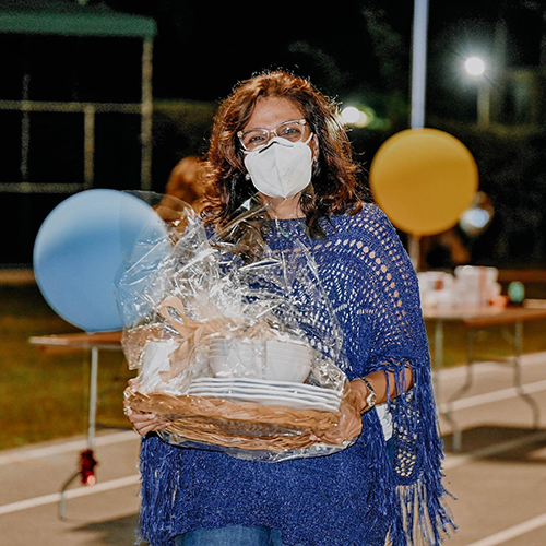 A woman walks away with her winnings at Immaculata-La Salle High School's Tricky Tray fundraising event March 18, 2021. Funds will go toward a new athletic field and fine arts building at the Miami high school.