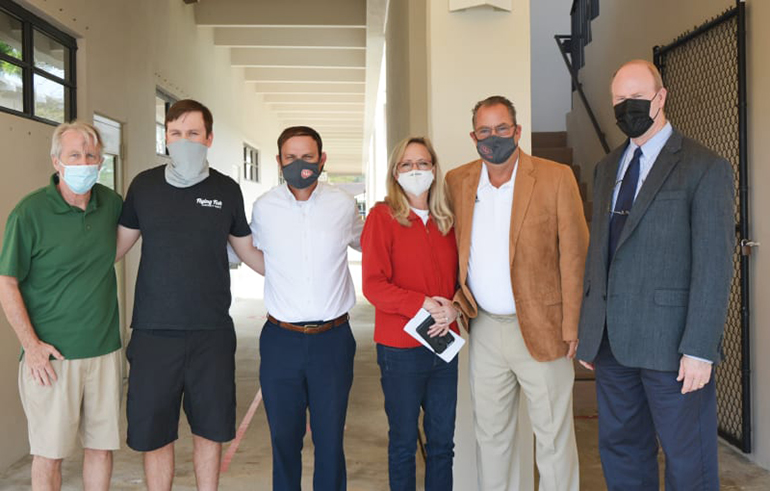 The Sivore family, creators of a scholarship for Cardinal Gibbons football players, pose with representatives of the Fort Lauderdale high school, from left: Tim Sivore, McKenna Sivore, head football coach Matt DuBuc, Paula Sivore, athletic director Mike Morrill, and Tom Mahon, Cardinal Gibbons president.