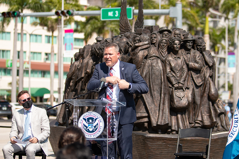 Brett Rinehart, director of the Miami and Caribbean district of USCIS, prepares to administer the oath of citizenship to 10 people at a ceremony held in the shadow of the "Angels Unawares" sculpture and Miami's Freedom Tower, March 24, 2021. 

The Archdiocese of Miami partnered with U.S. Citizenship and Immigration Services to hold the naturalization ceremony on the corner of Bayfront Park where the sculpture has been on display since Feb. 9, 2021. It will be moved to its next city, New Orleans, on April 8, 2021.