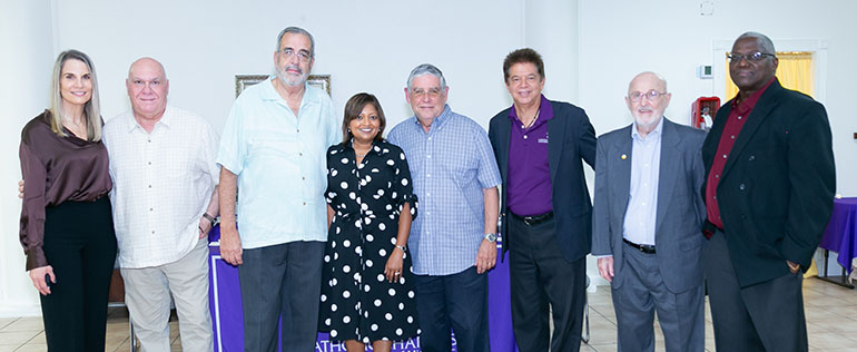 Catholic Charities employees pose with former Pedro Pans who are now members of the agency's board of directors after the 90th anniversary celebration, held March 26, 2021 at St. Joachim Church in Miami. From left: Gladys Palacios, John Louriel, Oreste Wrves, Mel Carmona, Devika Austin, Peter Routsis-Arroyo, Tom Comerford and Jules Jones.