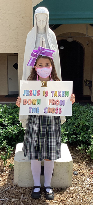 Third grader Valentina Martinez represents the 13th Station of the Cross during St. Theresa's 2021 COVID-friendly continuation of the Living Stations of the Cross tradition.