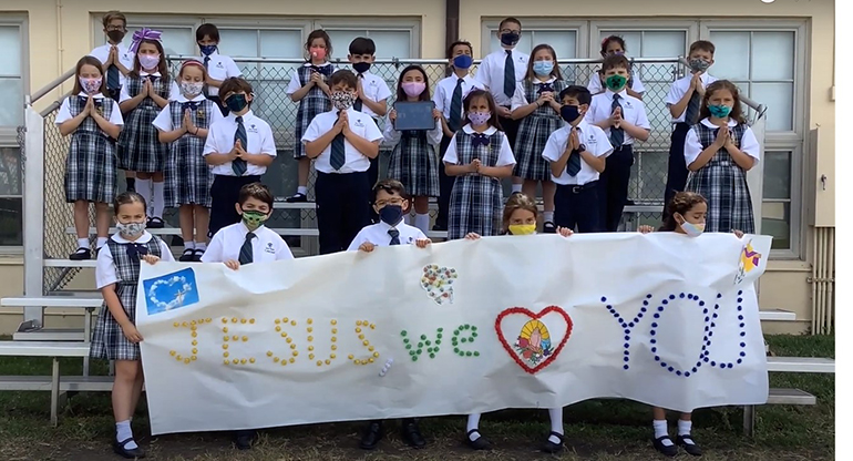 St. Theresa third graders, joined by the school's Honor Choir, conclude the annual Living Stations of the Cross safely and with love in 2021.