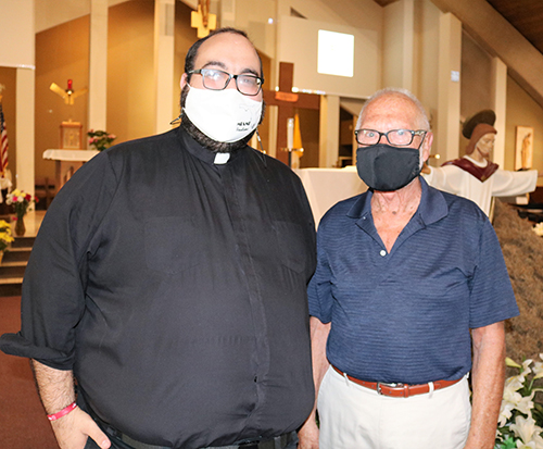 Father Matthew Gomez, vocations director for the Archdiocese of Miami, chats with Malcolm Meikle, president of the Serra Club of Broward County after a club gathering April 10, 2021 at St. Gabriel Church in Pompano Beach. The club collaborates with Father Gomez as part of their activities and mission.