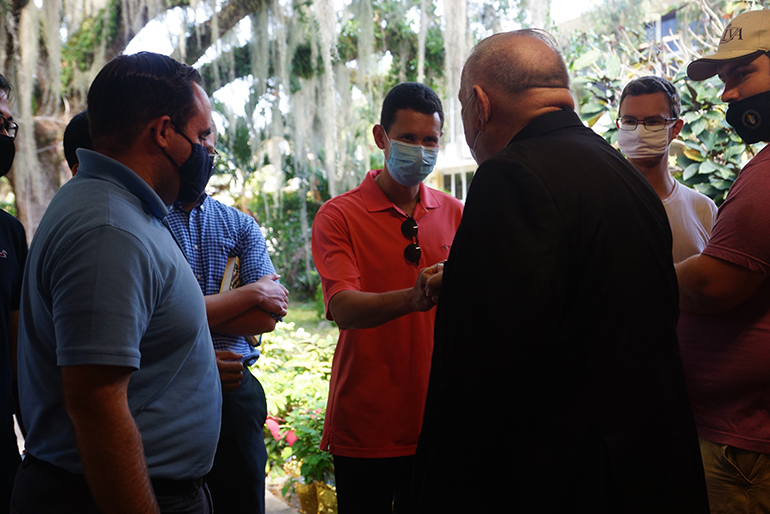 Archbishop Thomas Wenski chats with seminarians from St. John Vianney College Seminary in Miami who got vaccinated against COVID-19 at Notre Dame d'Haiti Mission in Miami on April 14, 2021.