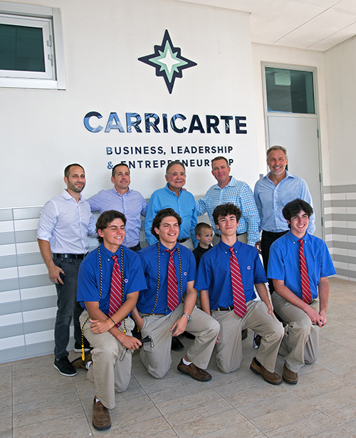 Members of the Carricarte family pose with business students at Christopher Columbus High School at an event April 15, 2021, marking the naming of the Carricarte Business, Leadership and Entrepreneurship career pathway at the all-boys Miami high school.