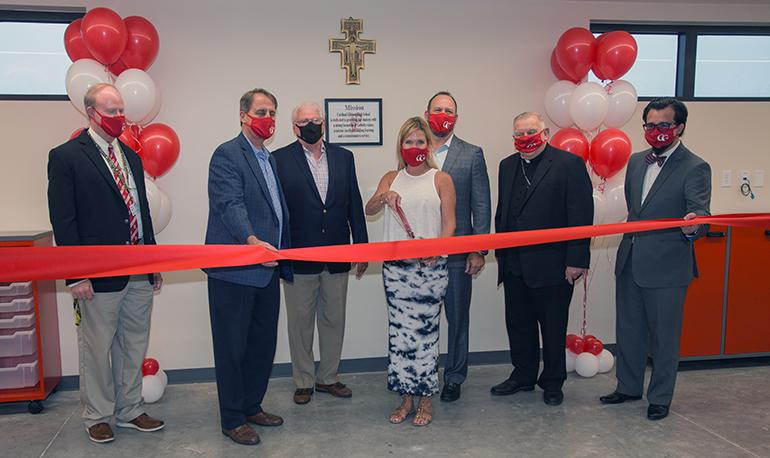 Cutting the ribbon to open the new Smith Family Building at Cardinal Gibbons High School, from left: Thomas Mahon, school president; Jack Seiler, member of the school's steering committee and former Fort Lauderdale mayor; Paul Ott, former school principal; donors Shaun Smith-Myers, Gibbons class of '89, and her husband, Charlie Myers; Archbishop Thomas Wenski; and Oscar Cedeno, Gibbons principal. The ceremony took place April 21, 2021.