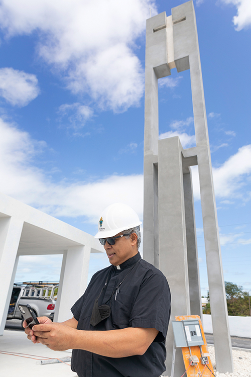 Father Jets Medina, parochial administrator of St. Peter Parish in Big Pine Key, stands in front of the bell tower that will make the rebuilt church more visible along U.S. 1.