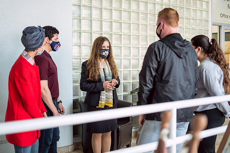 St. Thomas University law professor Roza Pati, seen here talking with some students, has been appointed by Pope Francis to the Dicastery for Promoting Integral Human Development. She had previously been appointed by Pope Benedict XVI to the Pontifical Council for Justice and Peace.