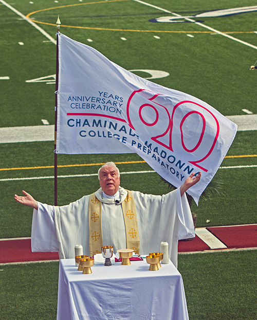 Marianist Father Robert Bouffier, school chaplain, celebrates the Mass marking Chaminade-Madonna College Preparatory's 60th anniversary, April 25, 2021 at the school's Vince Zappone Field.