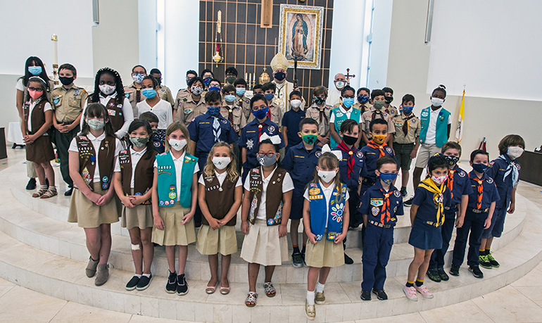 Archbishop Thomas Wenski poses for a photo with the Scouts after Mass the annual awards Mass for Catholic Scouts, celebrated May 1, 2021 at Our Lady of Guadalupe Church in Doral.