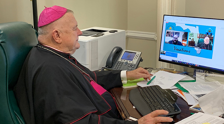 Archbishop Thomas Wenski listens as Father Matthew Gomez, archdiocesan director of vocations, introduces him during the virtual version of Focus 11, held May 5, 2021. Its goal is to help young people, specifically those age 11 or in sixth grade, to consider their vocation in general, and a vocation to the priesthood or religious life in particular. The event was held virtually this year due to the COVID-19 pandemic.