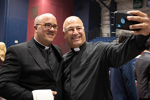 Father Elkin Sierra, right, takes a selfie with newly ordained Father Yosbany Alfonso after the ceremony.