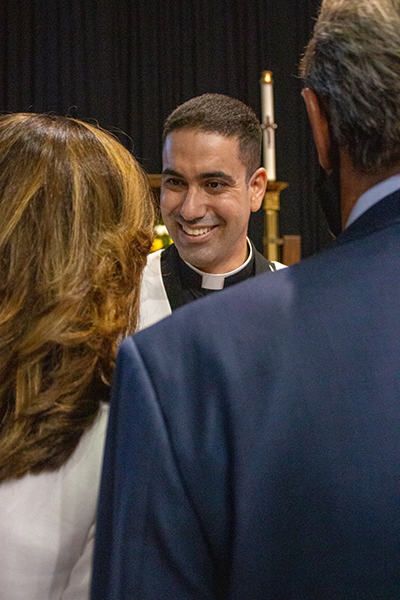 El P. Leandro Siqueira, recién ordenado, es felicitado por los invitados después de la ceremonia de ordenación.