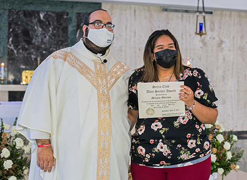 Melanie Morejon, 18, who has served weekly at Immaculate Conception Church in Hialeah even through the COVID pandemic, receives her altar server award from Father Matthew Gomez, chaplain of the Miami Serra Club and archdiocesan vocations director. The awards Mass was celebrated May 15, 2021 at St. John Vianney College Seminary in Miami.