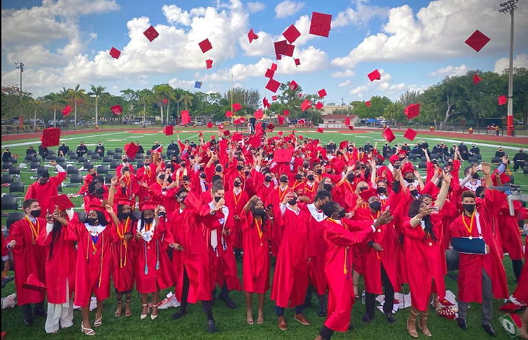 Msgr. Edward Pace High School's class of 2021 throw their caps into the air after their graduation ceremony, held May 28, 2021 on the school's new football field.