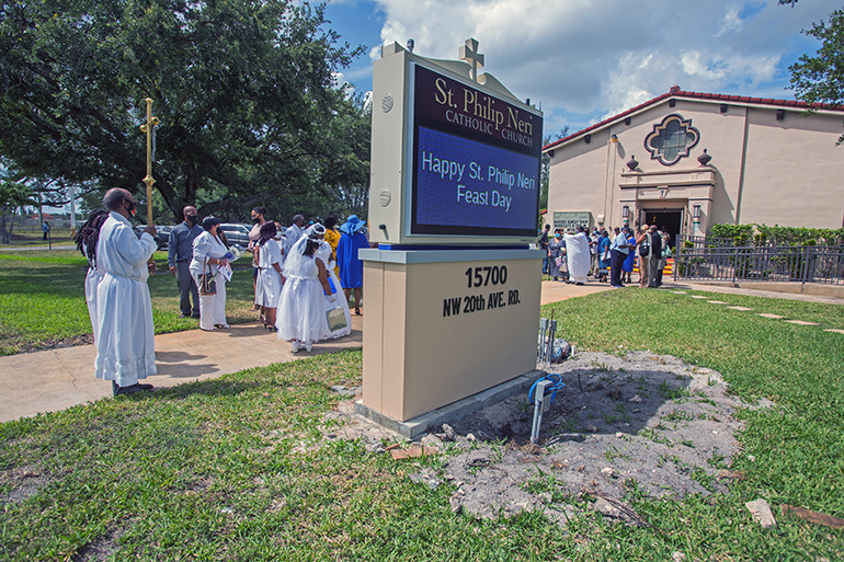 St. Philip Neri parishioners gather near their new digital sign for a blessing ceremony on Trinity Sunday, May 30, 2021.