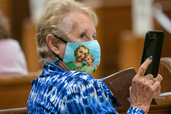 Magdalena Rodriguez of St. Stephen Parish in Miramar, snaps a picture of Archbishop Thomas Wenski before the start of the Mass. She is a 2021 graduate of the class taught at St. Bartholomew in Miramar. 

Archbishop Thomas Wenski presided at a Mass and graduation ceremony for the 2020 and 2021 School of Lay Formation classes, June 5, 2021 at St. Mary Cathedral. The graduation ceremony for the class of 2020 was postponed last year due to COVID-19.