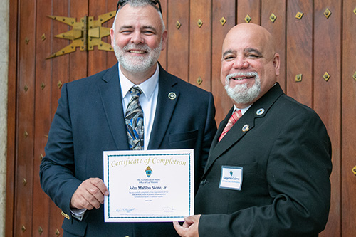 John Stone, left, and George Gutierrez, Knights on Bikes from St. John XXIII Parish in Miramar, pose for a photo after the graduation. 

 Archbishop Thomas Wenski presided at a Mass and graduation ceremony for the 2020 and 2021 School of Lay Formation classes, June 5, 2021 at St. Mary Cathedral. The graduation ceremony for the class of 2020 was postponed last year due to COVID-19.