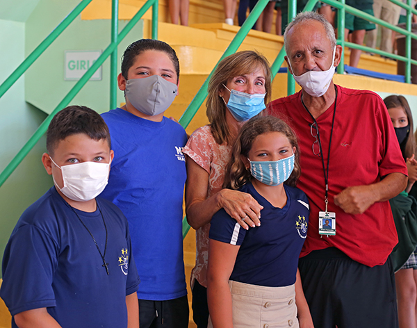 Art Fernandez poses for a photo with his grandchildren, Franco Fernandez, 9, Austin West, 12, and Samantha West, 10, and his wife, Lourdes Fernandez, after receiving the Key to the City of Miami Beach from Mayor Dan Gelber. Fernandez is retiring after 39 years as physical education teacher at St. Patrick School on Miami Beach.