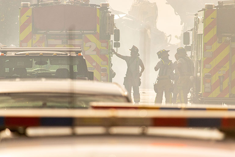 Fire rescue and search specialists at work June 25, 2021 near the partially collapsed Champlain Towers South in Surfside the day after the tragic event.