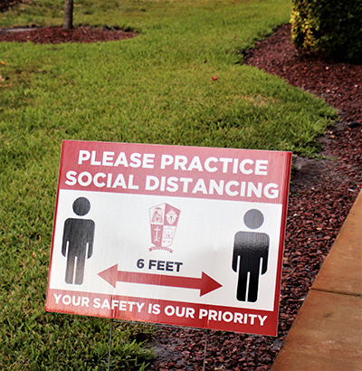 Distancing signs are part of Cardinal Gibbons High's campus during the pandemic days.