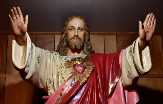 Jesus shows his wounded hands and his Sacred Heart in a full-size statue.