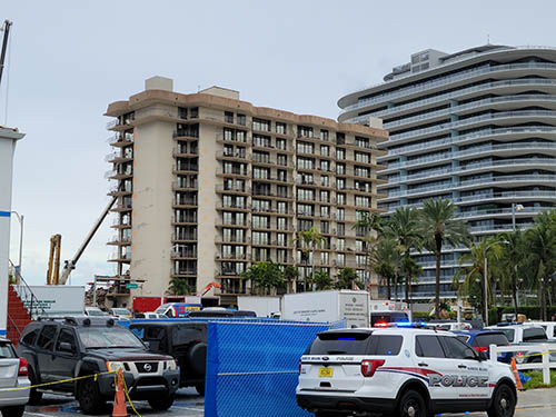 A view two streets west of the Champlain Towers South condominium in Surfside reveals part of the building that is still standing as recovery efforts continued June 30, 2021. Collins avenue, and its surrounding perimeter, have served as a major disaster recovery site with local, state, national, and international assistance on site.