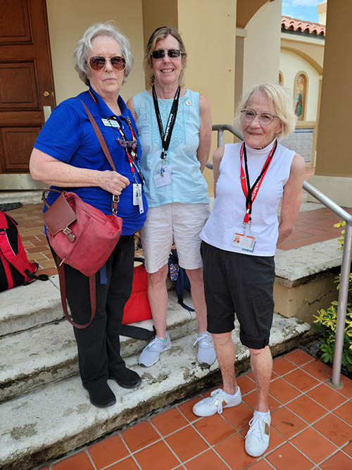 Volunteers from the Red Cross, all retired nurses, take a break from the heat on the steps of St. Joseph Church in Miami Beach on July 1, 2021, during recovery efforts for the Champlain Towers South building collapse. From left: Leslie Roberts, from Austin, Texas, Pat Duncan from Eustis, Florida, and Shirlee Reding from Des Moines, Iowa.