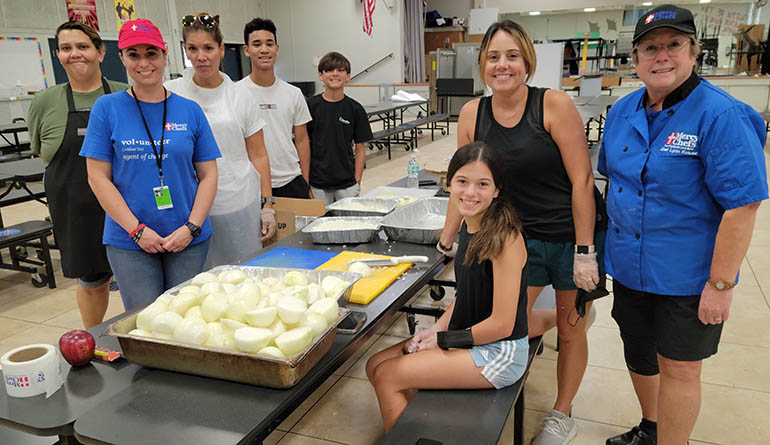 Chef Lynn Krause, of Mercy Chefs, poses with her team of volunteers who have been cooking from June 25 to July 15, 2021 for first responders and others working on site at the Champlain Towers South building collapse. Mercy Chefs is a faith-based nonprofit disaster relief organization. They are cooking at St. Joseph Church’s parish center, Minnotte Hall.