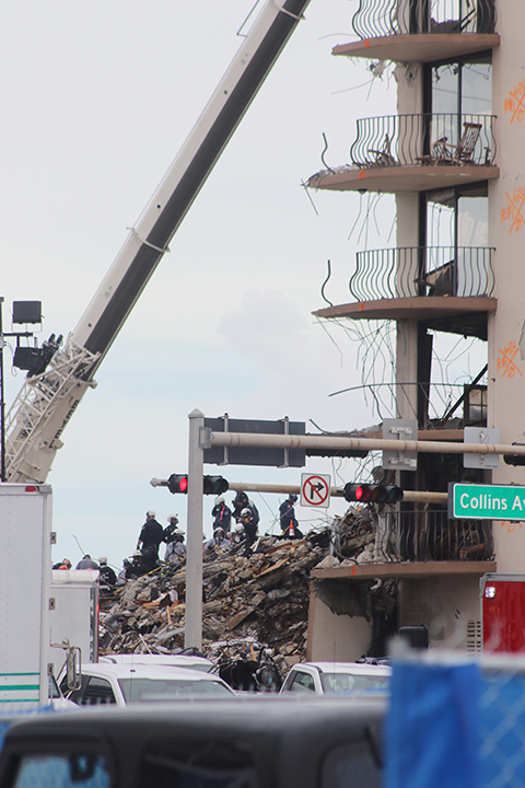 Search and rescue teams look for survivors among the rubble of the partially collapsed Champlain Towers South condominium in Surfside, June 30, 2021. A few days later, on July 4, the part of the building that remained standing was demolished by the authorities to speed up the search and rescue process.