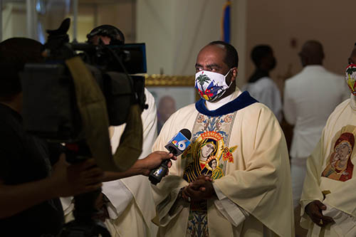 Father Reginald Jean-Mary, administrator of Notre Dame d'Haiti Catholic Church in Miami, speaks with the media June 22, 2021, at a memorial service for the late Jovenel Moise, a day before the former president of Haiti received a state funeral following his assassination July 7. President Moise was laid to rest July 23 by his wife and three children in their hometown of Cap-Haitien, Haiti.