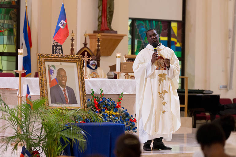 Father Youry Jules, parochial vicar of Notre Dame d'Haiti Catholic Church in Miami, leads prayers for peace in Haiti on June 22, 2021, at a memorial service for the late Jovenel Moise a day before the former president of Haiti received a state funeral following his assassination July 7. President Moise was laid to rest July 23 by his wife and three children in their hometown of Cap-Haitien, Haiti.