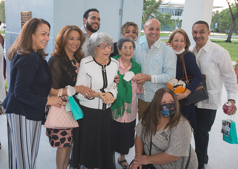 Sofia Ruiz and Reina Marmolejos, center, pose for a photo with a few members of their family after the Mass marking the first World Day for Grandparents and the Elderly, July 25, 2021. Miami Auxiliary Bishop Enrique Delgado celebrated the Mass at St. Thomas University's St. Anthony Chapel.