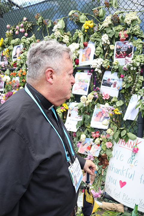 Father Juan Sosa, pastor of St. Joseph Church, Miami Beach, pays a visit July 2, 2021 to the memorial wall for the victims of the Champlain Towers South collapse in Surfside, a number of whom were members of his parish.