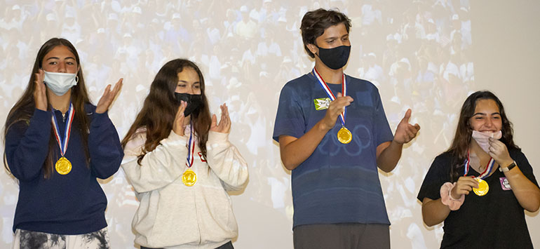 Members of the first place team take part in the award ceremony at the conclusion of the Blessed Trinity Life Teen Office Olympics, Sept. 12, 2021. From left: Natalia Perez from Our Lady of Lourdes Academy, Isabella Travieso from St. Brendan High School, Jacob Caudle from Belen Jesuit Preparatory School, and Gena Escanaverino from St. Brendan High School.