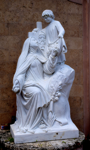 St. Therese adores an image of Jesus in this full-size statue, recalling her formal name, St. Therese of the Child Jesus and the Holy Face. The statue is at Little Flower Church in Coral Gables.