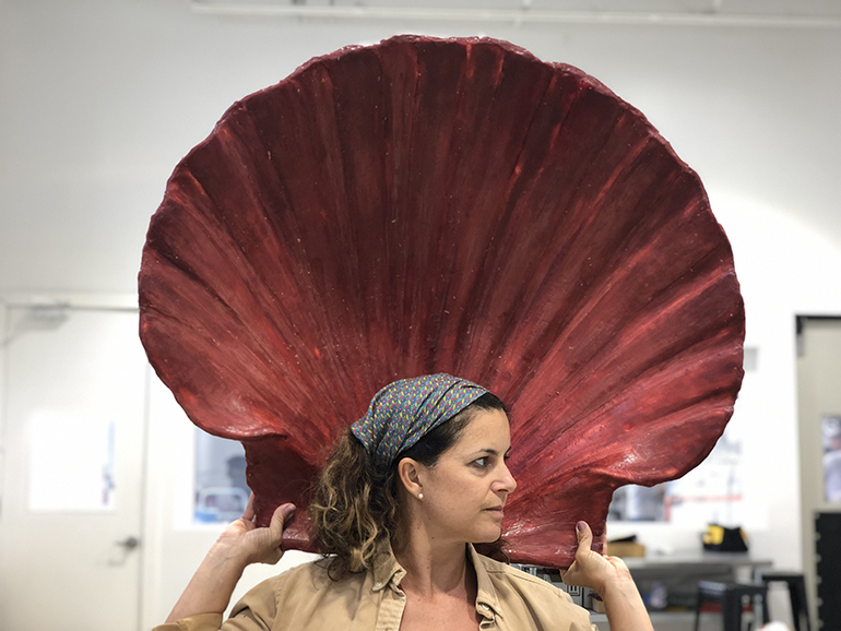 Natalie Plasencia poses with a model of the shell shaped baptismal font she created for the new St. Peter Church in Big Pine Key.