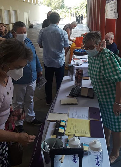 Catholic Charities' Monica Farias signs up prospective foster parents after Masses Sept. 12, 2021, Grandparents Day, at St. John Neumann Church in Miami. Farias is looking for homes for four small Afghanistan children transported here from Qatar by the US State Department.