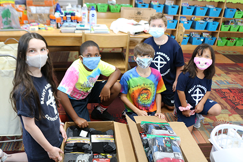 Fourth-graders pack boxes with donations collected as part of a drive at St. Ambrose School in Deerfield Beach for the observance of the 20th anniversary of the Sept. 11 attacks.