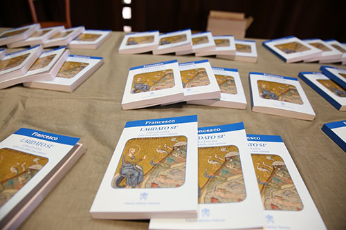 Copies of Pope Francis' encyclical "Laudato Si" are shown at a press conference in Paul VI Hall in Vatican City on the day it was released, June 18, 2015. The name of the encyclical is taken from St. Francis of Assisi's medieval Italian prayer “Canticle of the Sun.” The encyclical addresses the environment, climate change, abortion, embryonic experimentation, and population control.