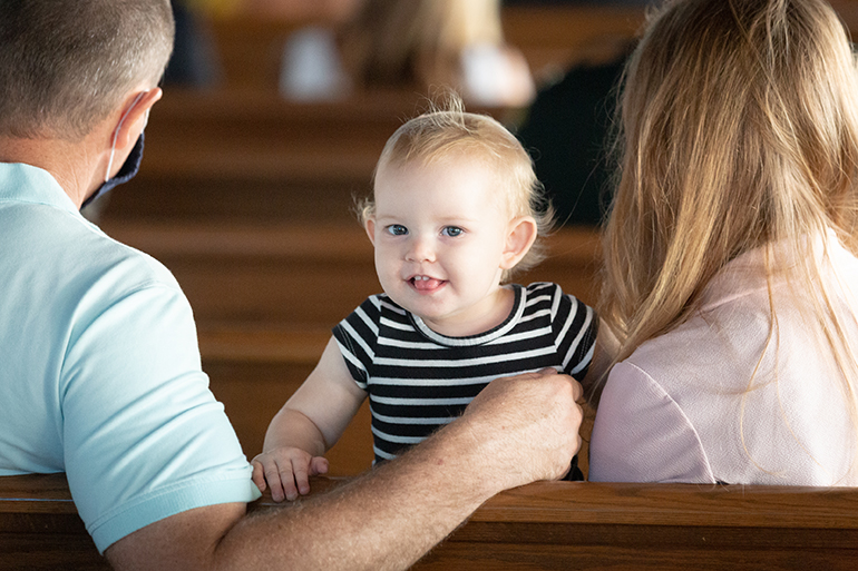 Local residents Brad and Joanna Morris and their one-year-old baby, Lexi, members of St. Peter the Fisherman Parish in Big Pine Key, attend the dedication Mass on Sept. 25, 2021.