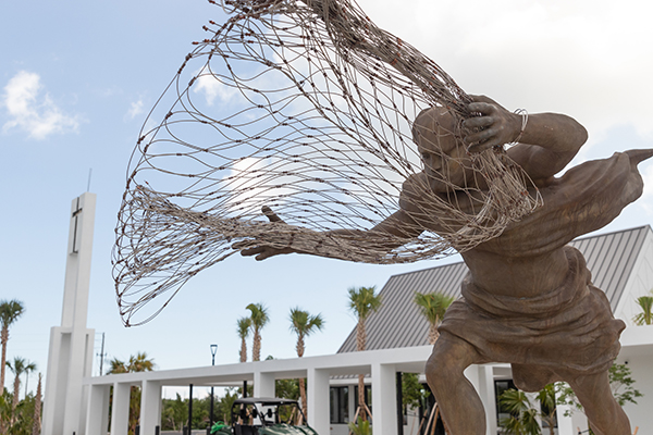 Esta escultura de San Pedro Pescador echando la red adorna la entrada principal de la nueva iglesia de St. Peter the Fisherman, en Big Pine Key. La iglesia recién terminada, el salón parroquial y la residencia de los sacerdotes en los Cayos Bajos de La Florida, inaugurados el 25 de septiembre de 2021, sustituyen a las antiguas instalaciones que fueron destruidas por el huracán Irma de 2017.