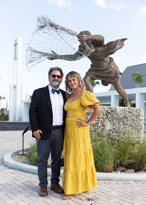 Juan Calvo, from Oppenheim Architecture who designed the new St. Peter the Fisherman Church in Big Pine Key, and his artist-wife, Natalie Plasencia, who created much of the new religious artwork there, stop for a picture in front of her sculpture of St. Peter casting his net prior to the dedication Mass Sept. 25, 2021. The newly completed church, parish hall and priests' residence in the Lower Florida Keys replace the old facility which was mostly destroyed by 2017â€™s Hurricane Irma.