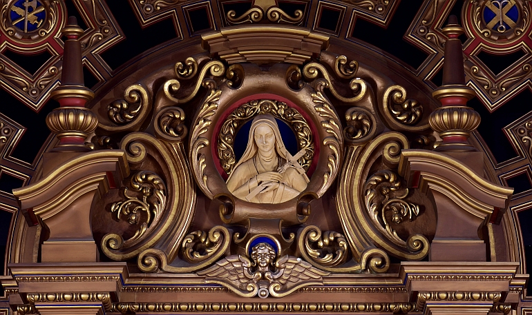 Elaborate scrollwork frames a portrait of St. Therese at Little Flower Church in Coral Gables.