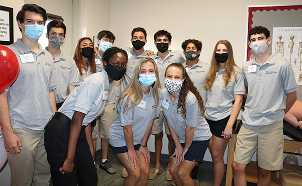 Seniors at Cardinal Gibbons High School gather for photos during the celebration and official opening of their school's new Emergency Medical Technician Program, in which they are enrolled. The program is made possible through Barry University in Miami Shores.