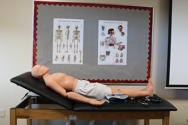 Charts, medical training equipment and devices are displayed during the blessing and ribbon-cutting ceremonies, Sept. 24, 2021, for Cardinal Gibbons High School's new Emergency Medical Technician program.