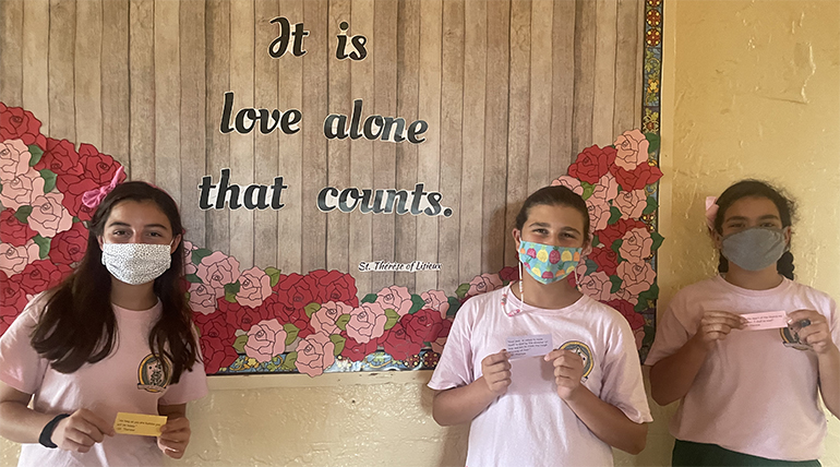 St. Theresa School students Carolina Alvarez, Olivia Rodriguez, and Isabella Heredia shared their talent at the Mass in honor of St. Therese by playing the bells in the choir. They are wearing pink to promote Breast Cancer Awareness during the month of October.