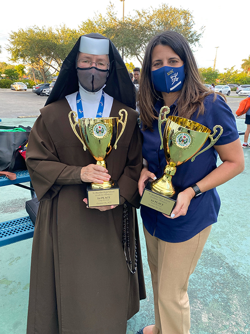 The principals of the winning schools at St. Brendan High School's Academic Olympics, Carmelite Sister Rosalie Nagy, of St. Theresa School in Coral Gables, and Yesi Feria De La Torre, of Mother of Christ School in Miami, pose with their respective first place trophies after the competition, Oct. 20, 2021. St. Theresa won first place in the Large School Division, Mother of Christ in the Small School Division.