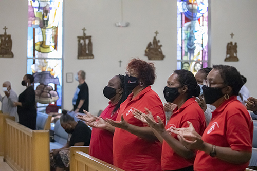 Faithful gathered at St. Bartholomew Church in Miramar pray during the Mass that marked the start of Black Catholic History Month, Nov. 6, 2021. Those wearing red shirts are members of the Archdiocese of Miami's Office of Black Catholic Ministry, which helped organize the Mass.